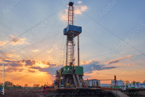 oil rig for drilling under oil and gas at sunset. Drilling oil and gas wells