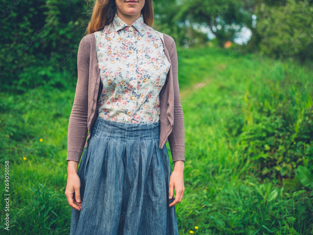Young woman standing in nature in the summer Young woman standing in nature in the summer