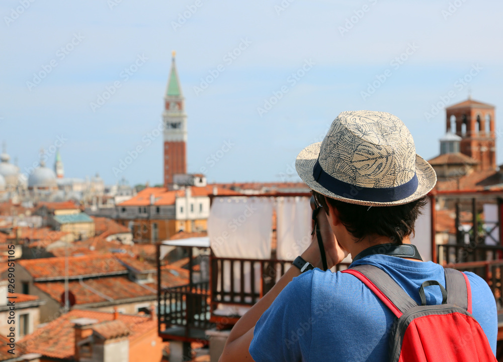 boy photographs the bell tower of the Basilica of San Marco in V boy photographs the bell tower of the Basilica of San Marco in V