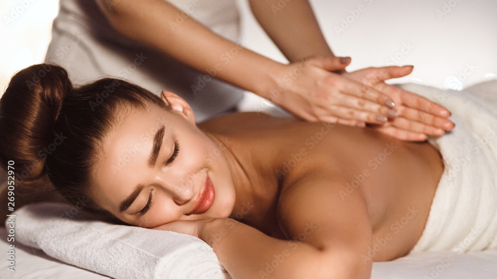 Woman Enjoying Relaxing Back Massage In Spa Centre Woman Enjoying Relaxing Back Massage In Spa Centre