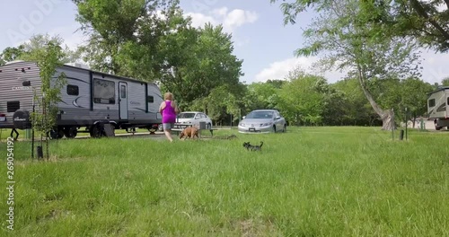Woman Walks Towards RV with Dogs