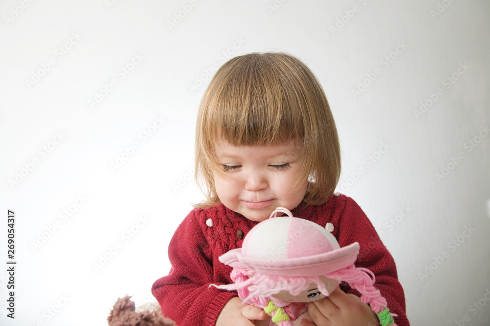 little girl smiling happy. cute caucasian baby with bear and doll isolated on white background little girl smiling happy. cute caucasian baby with bear and doll isolated on white background