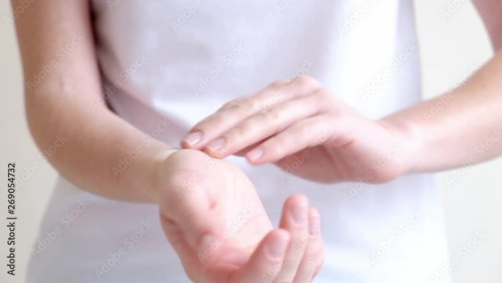Hands of a young woman applying hand cream, hands massage Hands of a young woman applying hand cream, hands massage