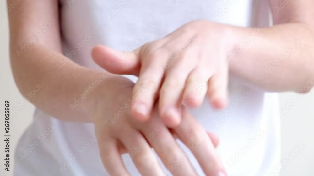 Hands of a young woman applying hand cream, hands massage Hands of a young woman applying hand cream, hands massage