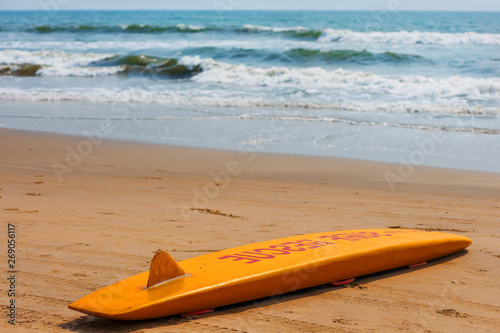 Photography The yellow board of the rescuer for surfing lies on the sand used by the lifegua
