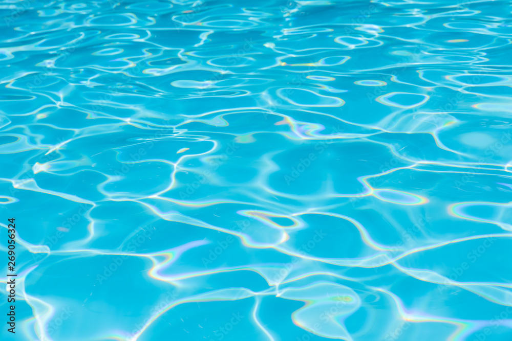 Blue and bright water in swimming pool with sun reflection, Motion of ripple water and gentle wave in pool