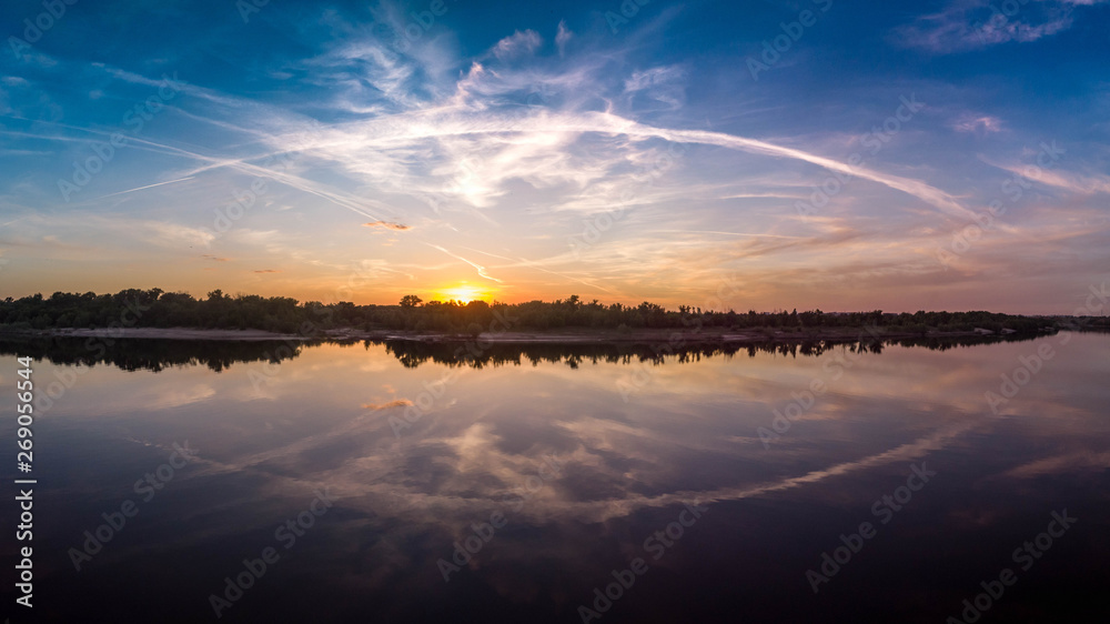 Beautiful landscape with reflection, blue sky and yellow sunlight in sunrise.
