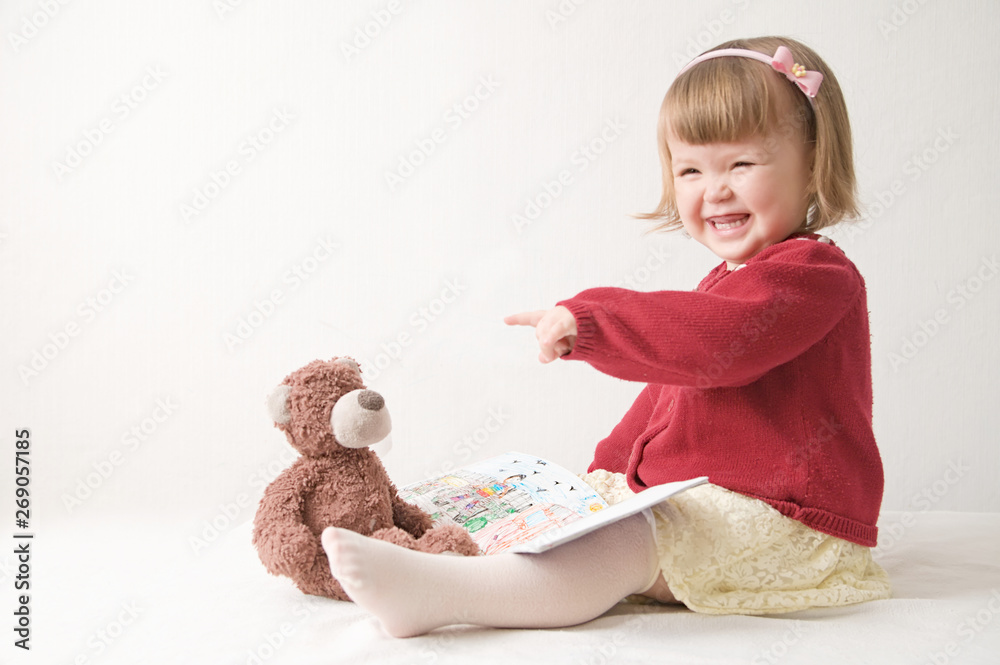 playing school with toys. happy smiling baby girl elegant in dress. cute caucasian baby with teddy bear playing school with toys. happy smiling baby girl elegant in dress. cute caucasian baby with teddy bear