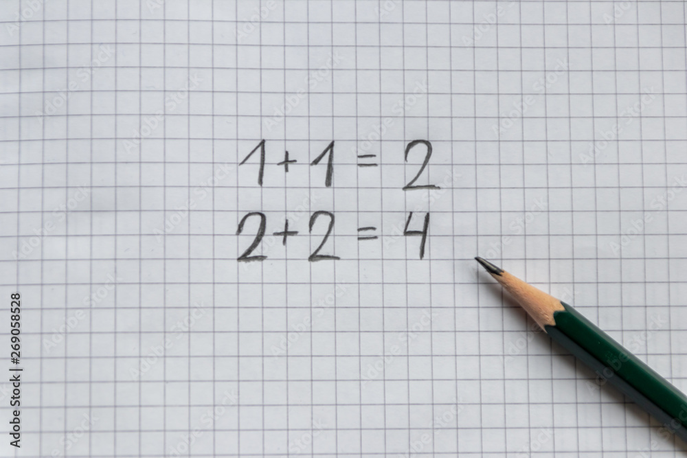 Einfache Rechenaufgabe für Grundschüler zum Schulanfang auf einem karierten Blatt Papier mit Bleistift Einfache Rechenaufgabe für Grundschüler zum Schulanfang auf einem karierten Blatt Papier mit Bleistift