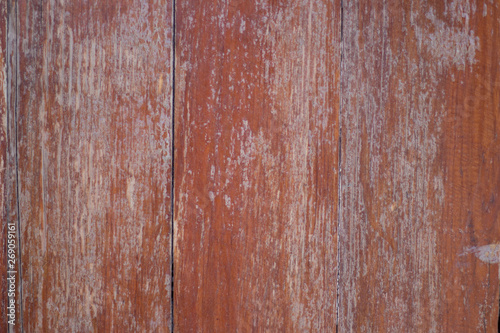 Close view of an old wooden fence painted with brown paint.