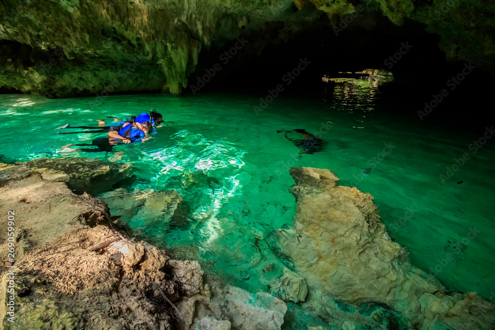 Some people is swimming and snorkeling on Gran Cenote Yucatan