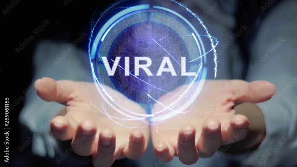Female hands show a round conceptual hologram with text Viral. Unrecognizable woman in ashen white on a black background with future holographic technology