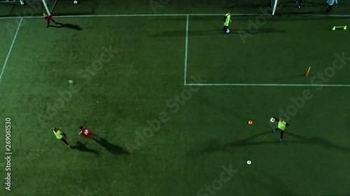 The drone flies follow the footballers.