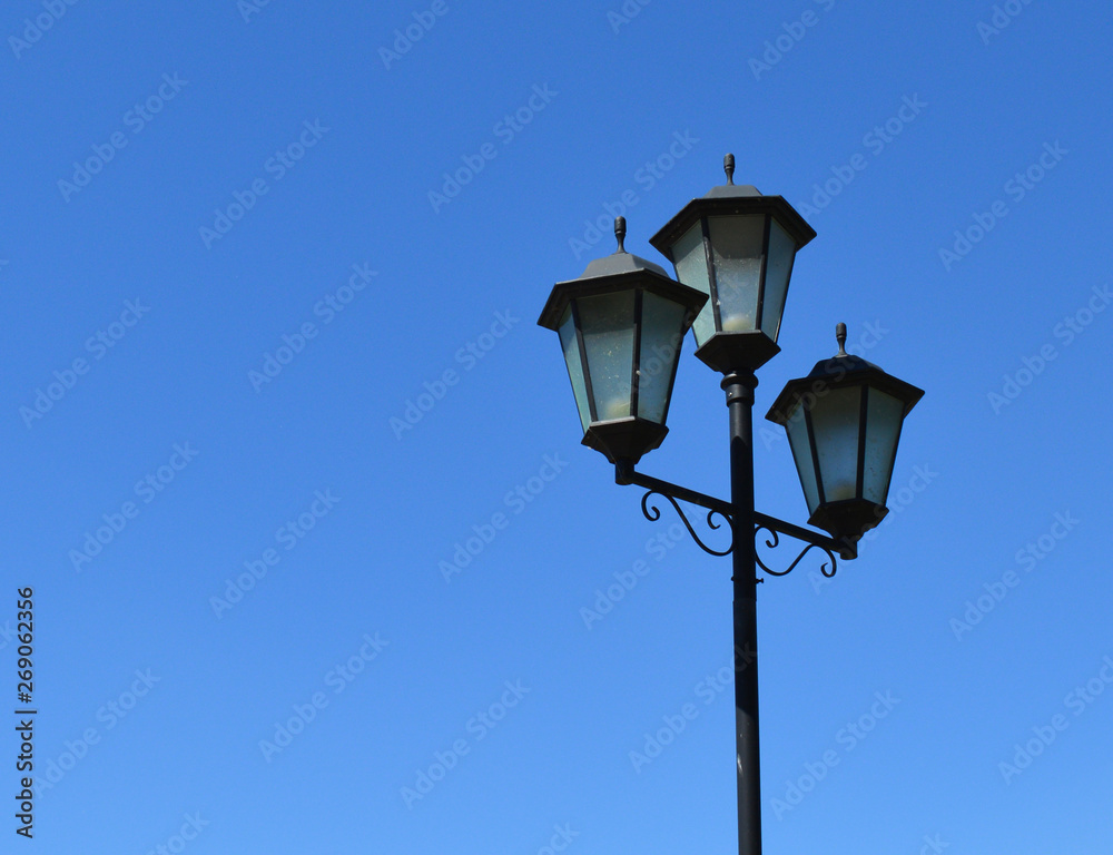 three black metal lanterns for road lighting at night three black metal lanterns for road lighting at night