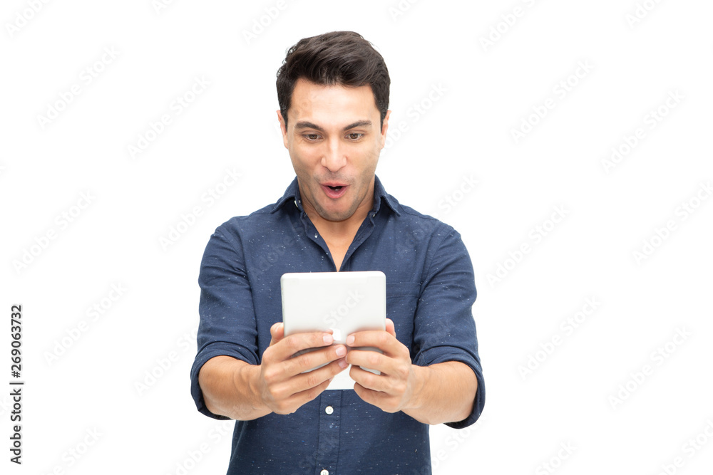Portrait of an excited man playing games on tablet isolated over white background, Wow expression concept Portrait of an excited man playing games on tablet isolated over white background, Wow expression concept