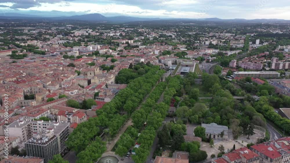Aerial drone back traveling over esplanade Charles de Gaulle Montpellier Corum alley with trees spring sunrise Aerial drone back traveling over esplanade Charles de Gaulle Montpellier Corum alley with trees spring sunrise