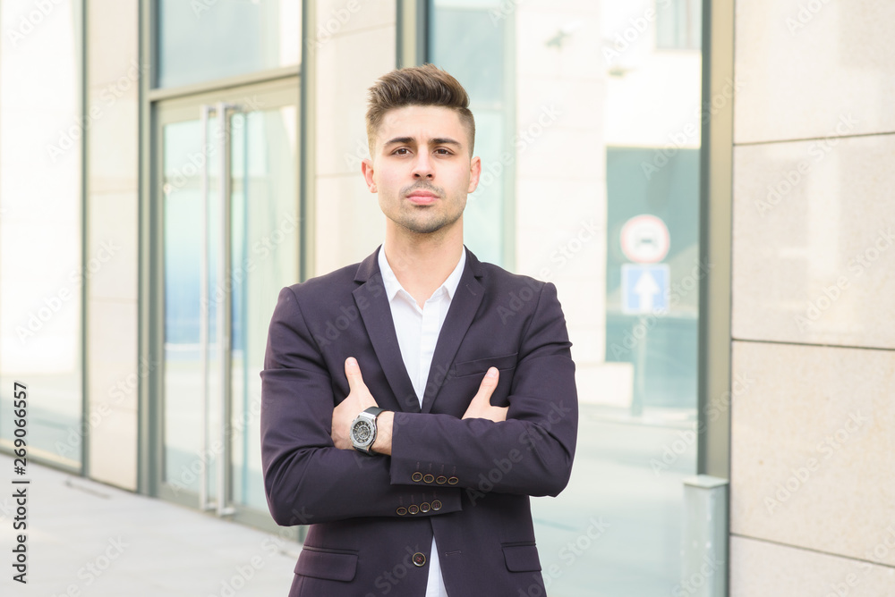 Portrait of successful businessman open in modern city near business center Portrait of successful businessman open in modern city near business center