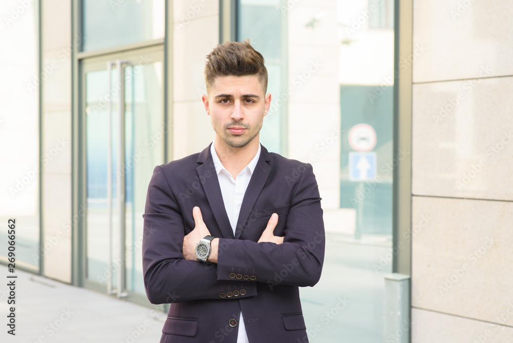 Portrait of successful businessman open in modern city near business center Portrait of successful businessman open in modern city near business center