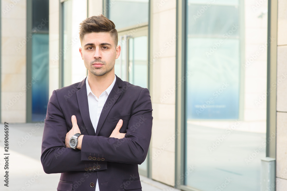 Portrait of successful businessman open in modern city near business center Portrait of successful businessman open in modern city near business center