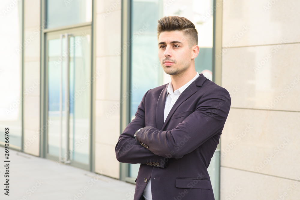 Portrait of successful businessman open in modern city near business center Portrait of successful businessman open in modern city near business center
