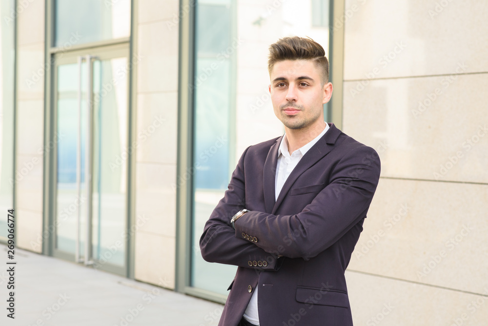 Portrait of successful businessman open in modern city near business center Portrait of successful businessman open in modern city near business center