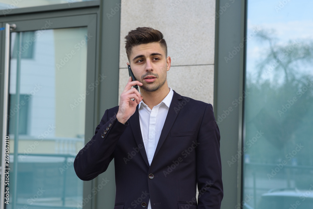 Portrait of successful businessman open in modern city near business center Portrait of successful businessman open in modern city near business center