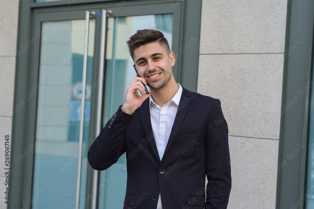 Portrait of successful businessman open in modern city near business center Portrait of successful businessman open in modern city near business center