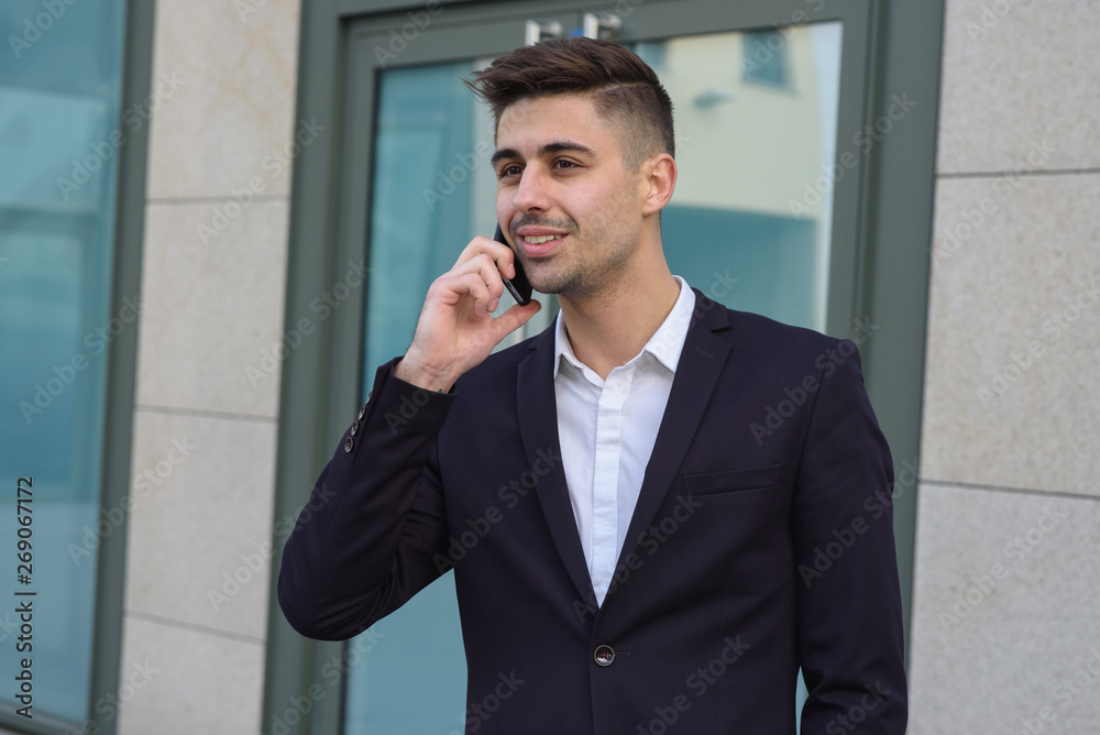 Portrait of successful businessman open in modern city near business center Portrait of successful businessman open in modern city near business center