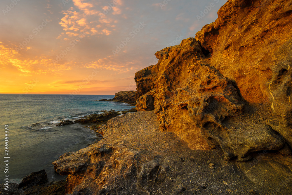 beautiful sea landscape - sunset over a rocky ocean cliff.Punta Papagayo, Lanzarote, Spain