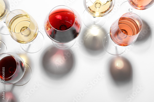Different glasses with wine on white background, top view