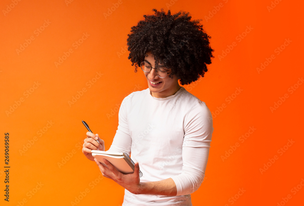 Cute african american millennial guy taking notes Cute african american millennial guy taking notes