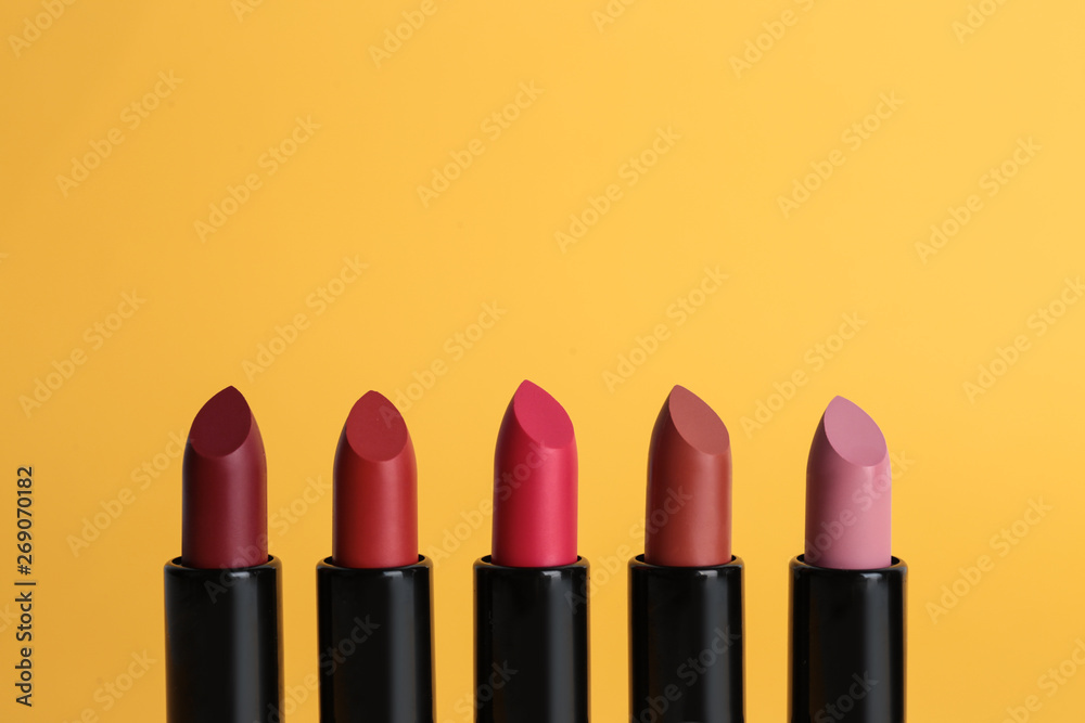 Obraz premium Different lipsticks on color background. Makeup cosmetic product