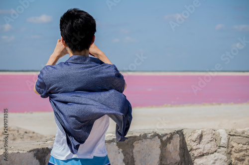 Someone is taking photos and video of the pink lake Las Coloradas in Yucatan Mexico. Cancun Tulum