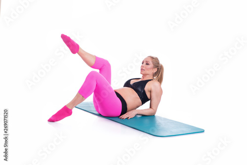 Beautiful happy pregnant women doing exercise with mat on the white background