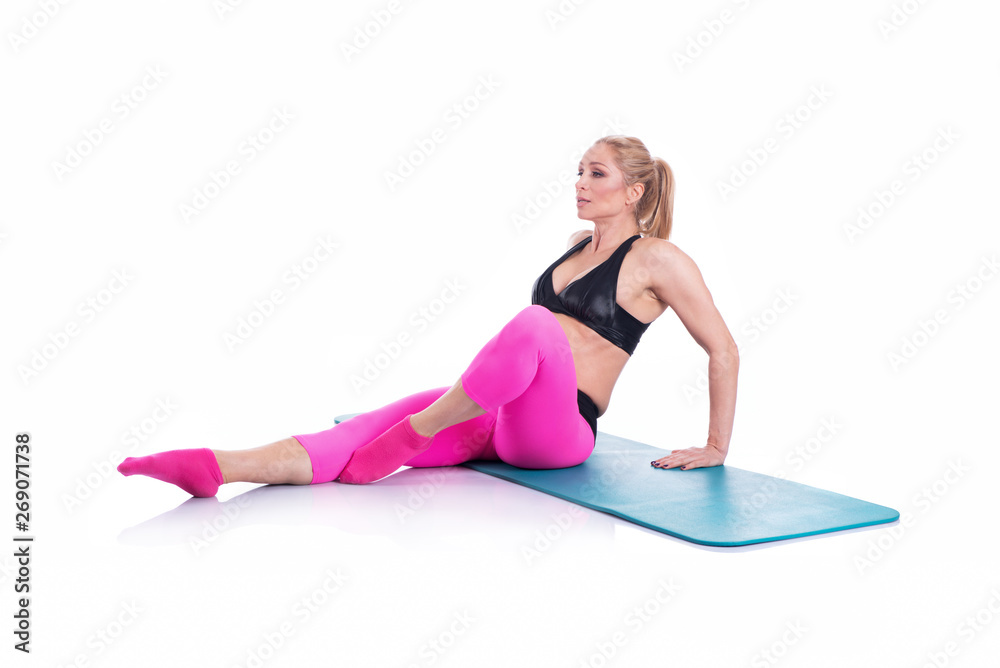 Beautiful happy pregnant women doing exercise with mat on the white background Beautiful happy pregnant women doing exercise with mat on the white background