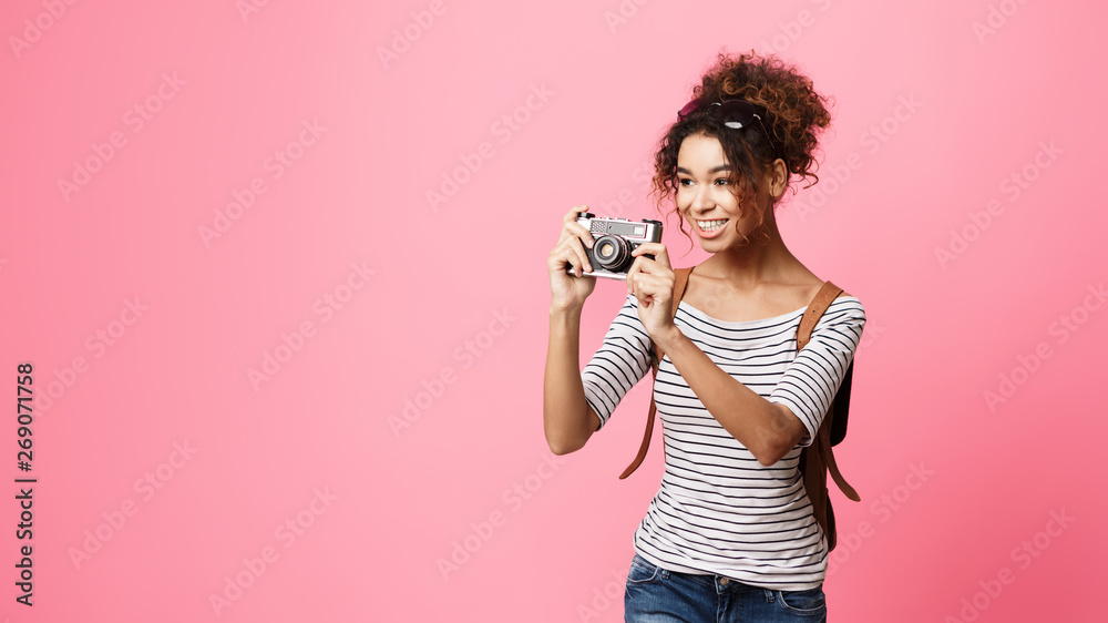 Obraz premium African-American Traveller Taking Photo On Retro Camera