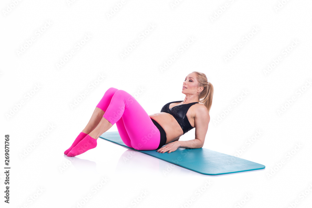 Beautiful happy pregnant women doing exercise with mat on the white background