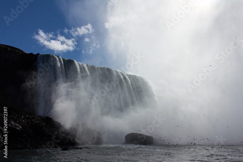 Niagara falls on a sunny day  with mist obscuring the sun