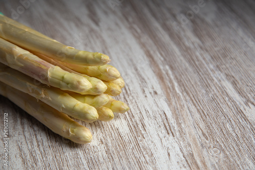 A handful of white asparagus on a rustic table