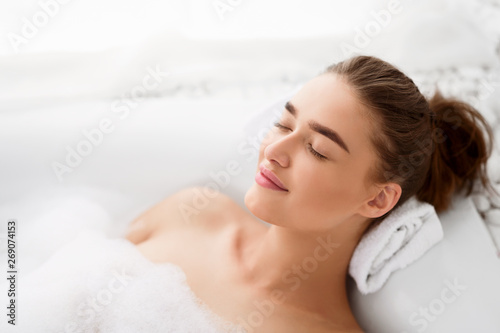 Young Woman Enjoying Pleasant Bath With Foam