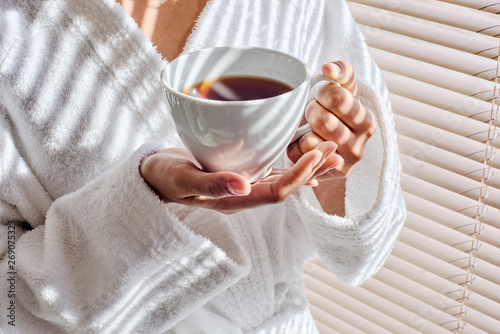 Hands holding cup of tea