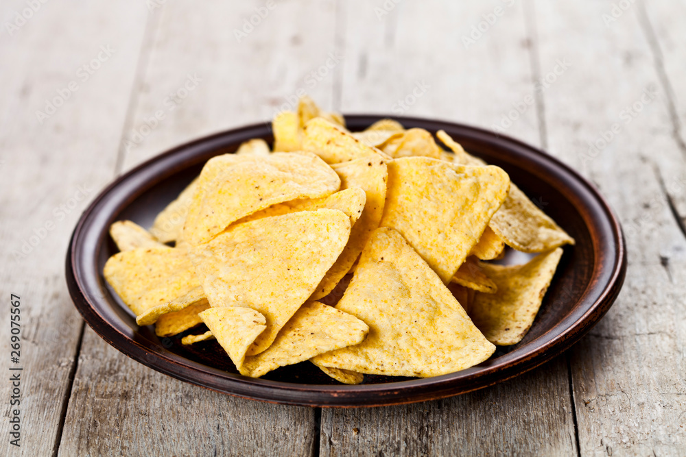 Nachos chips on brown ceramic plate. Nachos chips on brown ceramic plate.