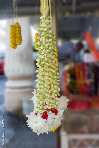 Jasmine garland traditional handcraft decoration for pray to Hindu gods.Flower garland for ritual sacrifice for sale placed on market stall. Floral garland for altar.