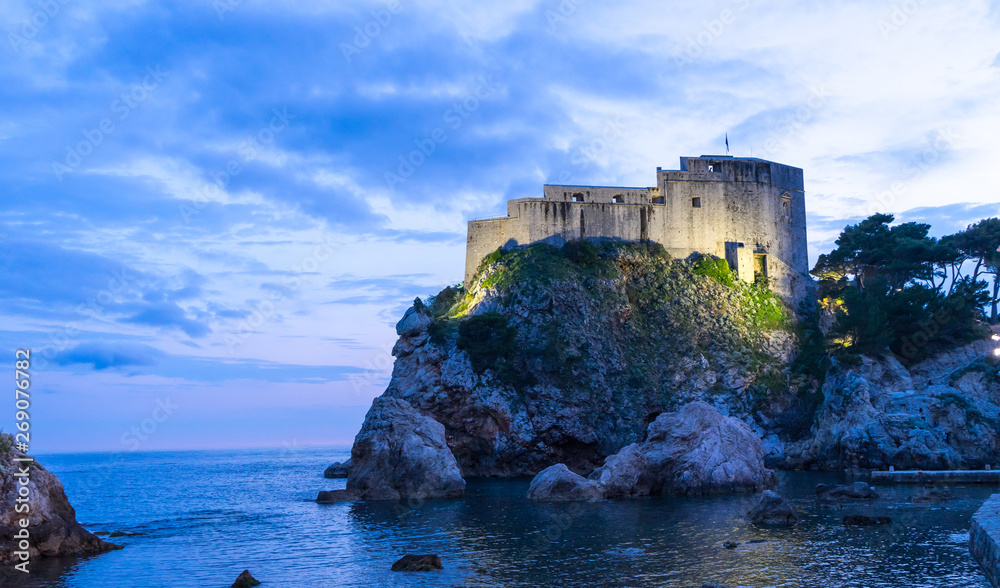 The historic wall of Dubrovnik Old Town, Croatia. Prominent travel destination of Croatia. Dubrovnik old town UNESCO World Heritage. Castle at night in the sea
