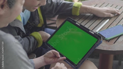 Mother and Son using digital tablet together, Green screen chroma key.
