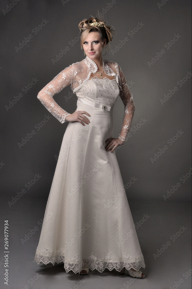 Studio photo of the bride in a white dress. Retro style.