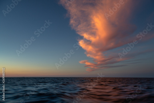 Unbelievable sunset in the ocean with the pink cloud 