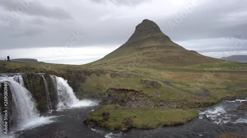 beautiful kirkjufell mountain in iceland with waterfall and clouds