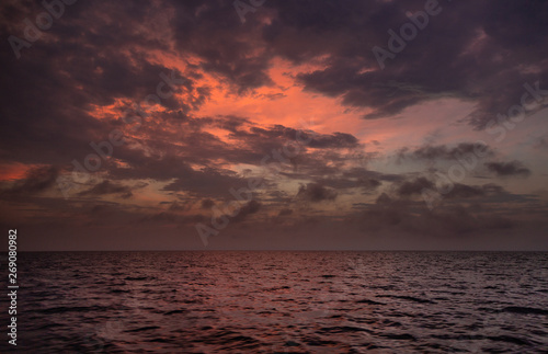 Amazing sunset with colourful clouds in the ocean