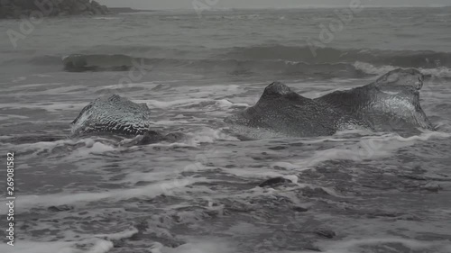water crashing on beautiful diamond beach in iceland ice